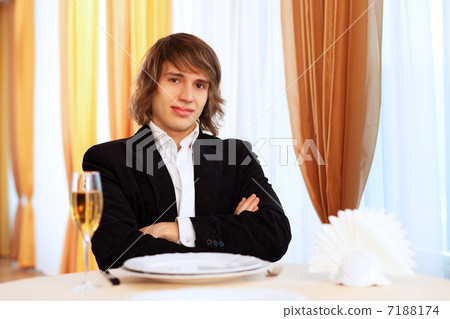 Young handsome man sitting in restaurant Young handsome man sitting in restaurant 7188174