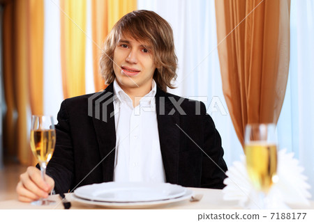 Young handsome man sitting in restaurant Young handsome man sitting in restaurant 7188177