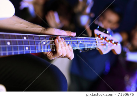 Young guitar player performing in night club 7190676