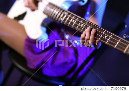 Young guitar player performing in night club 7190679