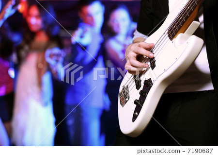 Young guitar player performing in night club 7190687