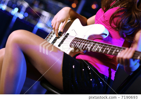 Young guitar player performing in night club 7190693