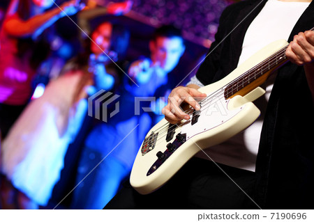 Young guitar player performing in night club 7190696