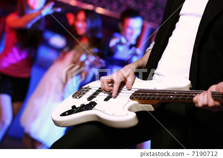 Young guitar player performing in night club 7190712