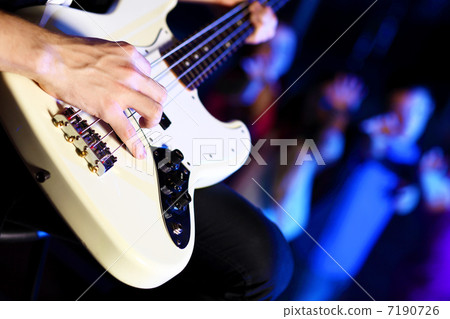 Young guitar player performing in night club 7190726
