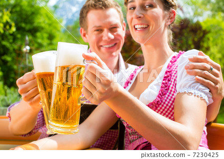 Happy Couple in Beer garden drinking beer Happy Couple in Beer garden drinking beer 7230425