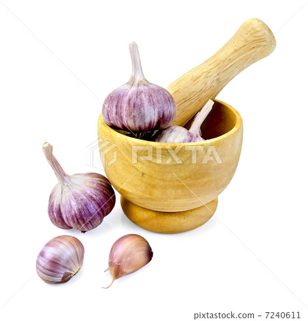 Garlic in a wooden mortar Garlic in a wooden mortar 7240611