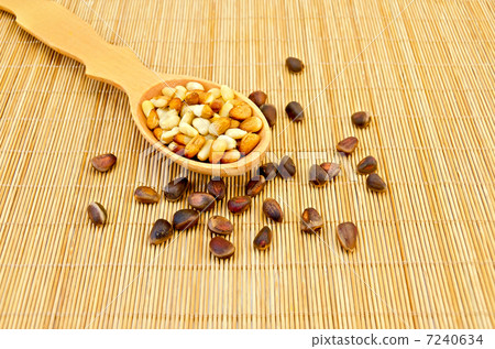 Nuts of cedar on a bamboo mat 7240634
