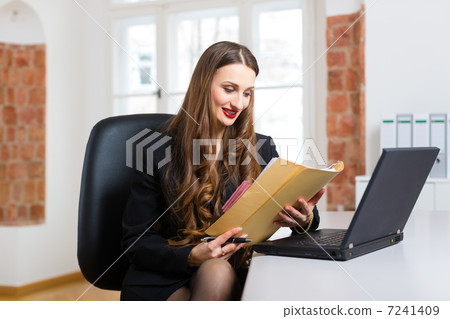woman in office sitting on the computer woman in office sitting on the computer 7241409