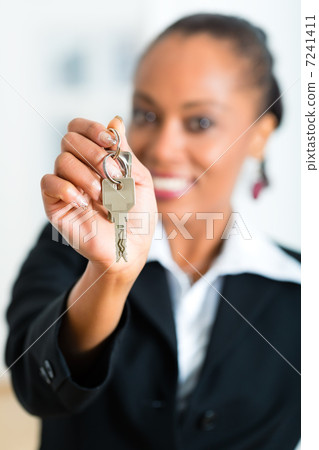 Young realtor with keys in an apartment Young realtor with keys in an apartment 7241411