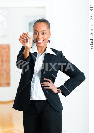 Young realtor with keys in an apartment Young realtor with keys in an apartment 7241414