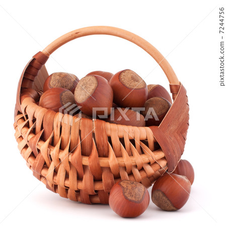 Hazelnuts in wicker basket Hazelnuts in wicker basket 7244756