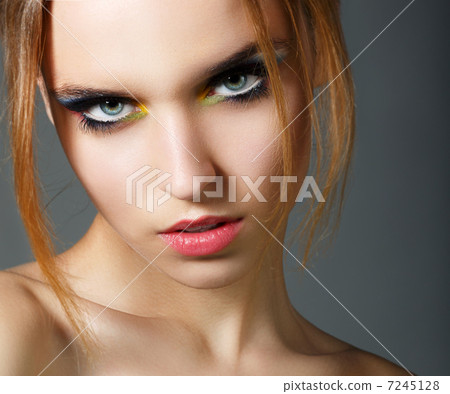 Magnetism. Character. Face of Young Red Hair Beauty with Colorful Eye Makeup 7245128
