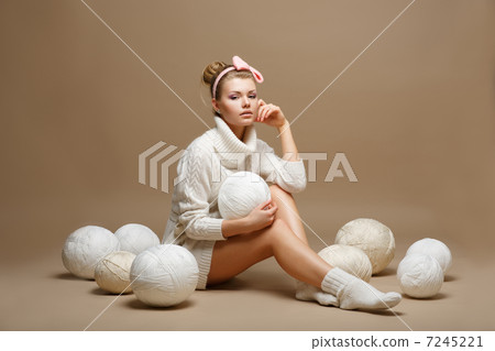 Housework. Woman in White Tricot with Woolen Balls. Seamstress 7245221