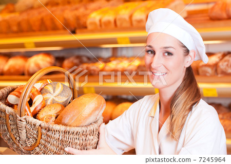 Female baker selling bread in her bakery 7245964
