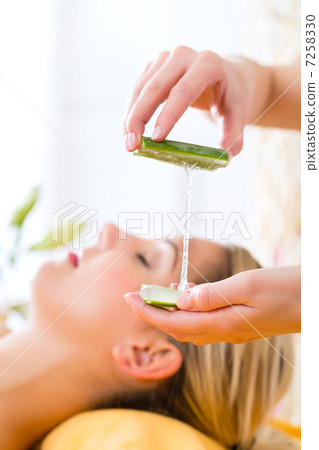 Wellness - woman having aloe vera application 7258330