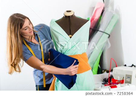 Fashion designer or tailor working in studio 7258364