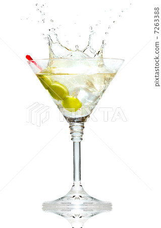 Olive splashing on martini glass isolated on white Olive splashing on martini glass isolated on white 7263388