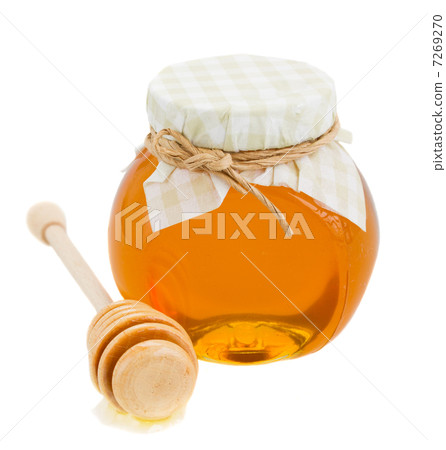 honey in glass pot and stick 7269270