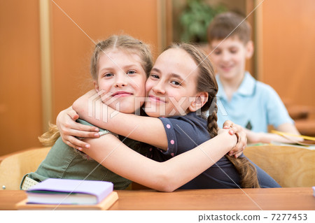 schoolmates at desk after lesson 7277453