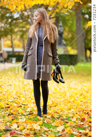 Girl on a fall day, with her shoes in hand Girl on a fall day, with her shoes in hand 7281234