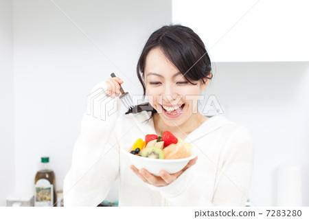 A woman eating fruit A woman eating fruit 7283280