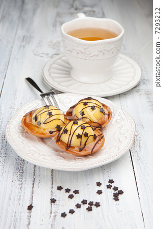 Sweet cakes with a cup of tea on a white table 7293212