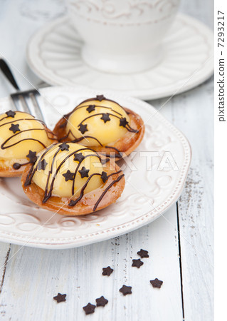Sweet cakes with cup of tea on white table 7293217