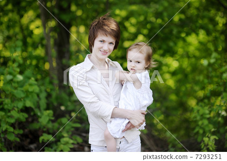Young mother holding her adorable girl 7293251