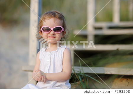 Adorable toddler girl sitting on the stairs 7293308