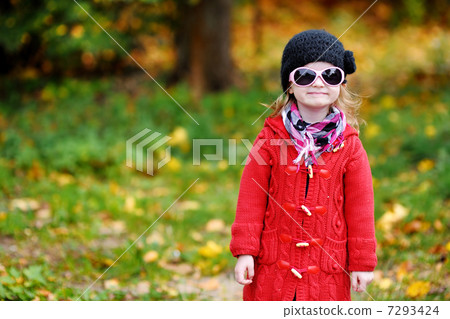 Adorable little girl on autumn day Adorable little girl on autumn day 7293424