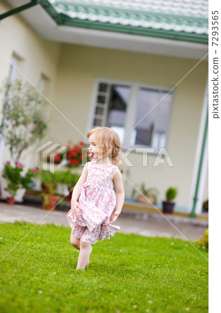 Adorable little girl in a yard Adorable little girl in a yard 7293565