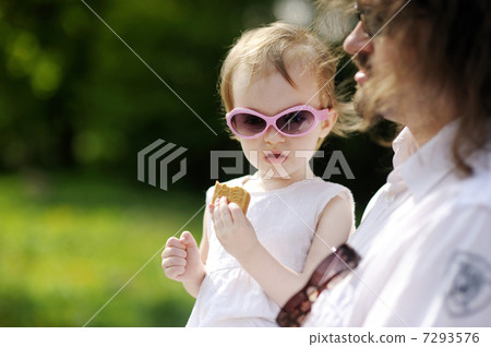 Funny toddler girl eating cookie Funny toddler girl eating cookie 7293576