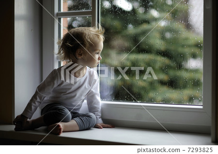 Adorable toddler girl looking at raindrops 7293825