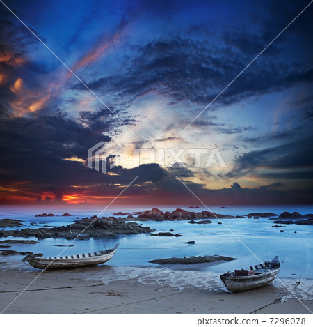 Traditional asian boats moored by the wave line. Long exposure s 7296078