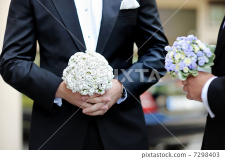 Groom and a bestman holding flowers Groom and a bestman holding flowers 7298403