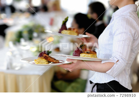 Waitress is carrying three plates 7298910