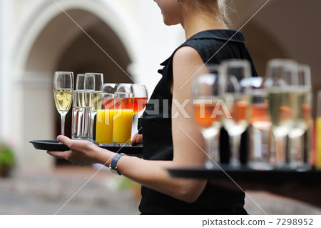 Waiter with dish of wine and juice glasses Waiter with dish of wine and juice glasses 7298952