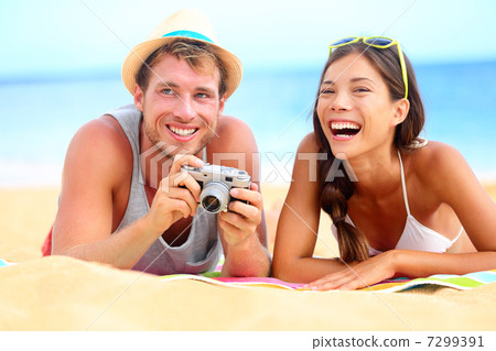 Young happy multicultural couple on beach 7299391