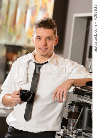 Attractive waiter leaning on espresso machine Attractive waiter leaning on espresso machine 7299638
