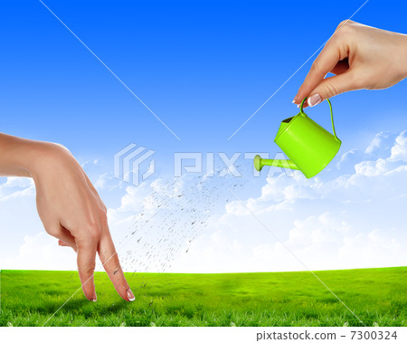 Hand with a small watering Hand with a small watering 7300324