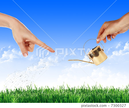 Hand with a small watering Hand with a small watering 7300327