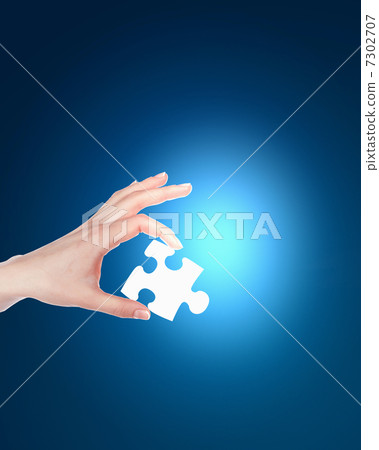 human hand with a piece of puzzle human hand with a piece of puzzle 7302707