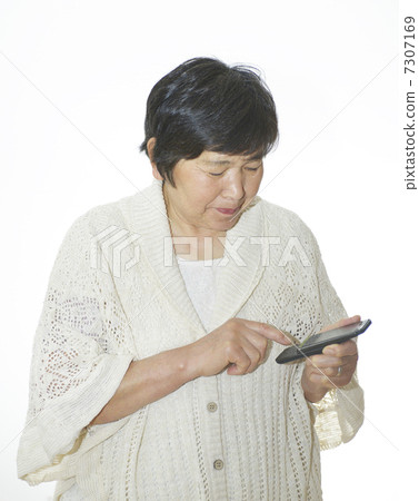 A woman using a mobile phone A woman using a mobile phone 7307169