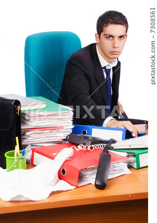 Young busy businessman at his desk Young busy businessman at his desk 7308561