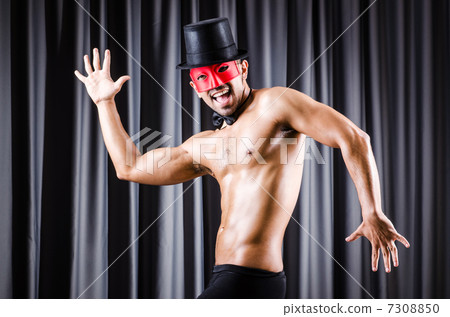 Muscular actor with mask against curtain 7308850