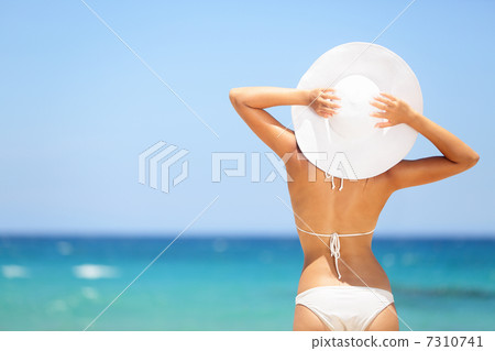 Happy woman enjoying beach relaxing in summer 7310741