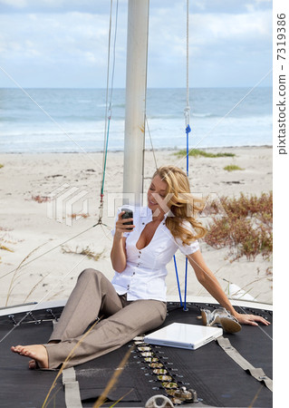 Beautiful Young Woman Sending Text On Boat At The Beach Beautiful Young Woman Sending Text On Boat At The Beach 7319386