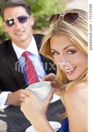 Beautiful Couple Man and Woman Having Drink At Cafe Beautiful Couple Man and Woman Having Drink At Cafe 7319388
