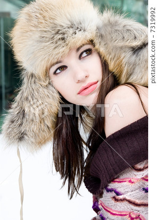 winter portrait of young woman in fur hat 7319992